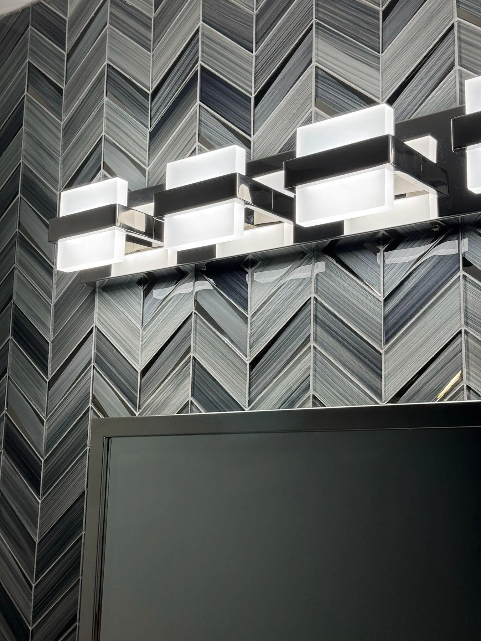 Charcoal chevron glass tile backsplash close-up