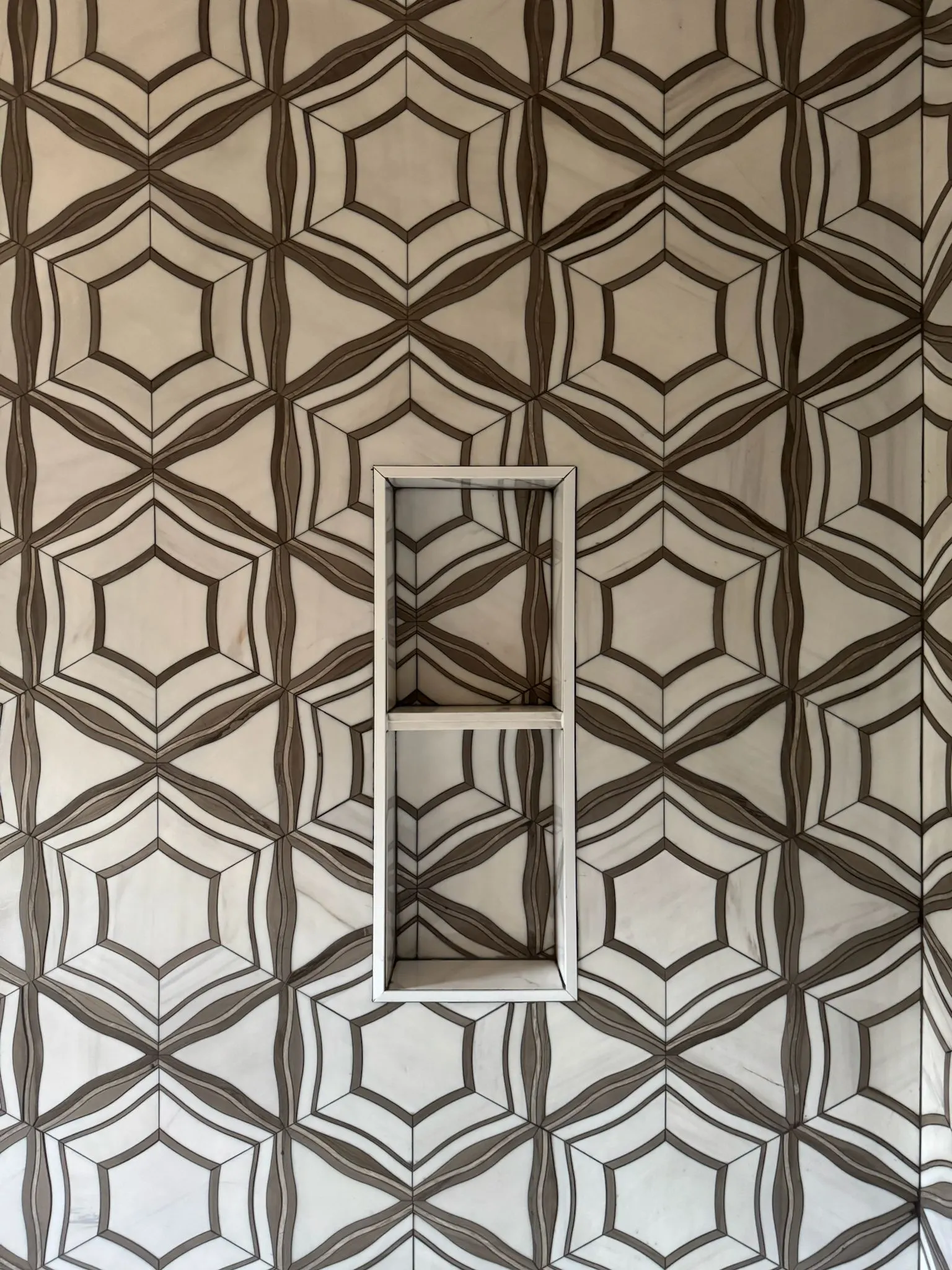 Marble star and hexagon tile feature wall with niche
